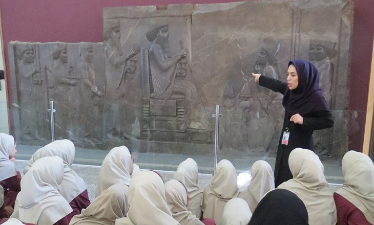 A teacher explaining the significance of a relief